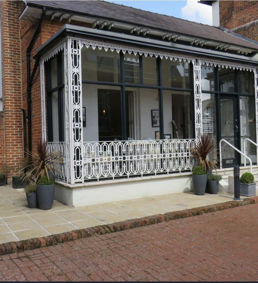 The studio's colonial-style ironwork veranda